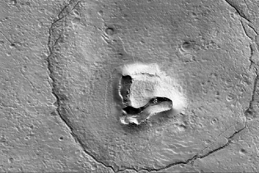 A Photograph of Mars craters in the shape of Smiling teddy bear.