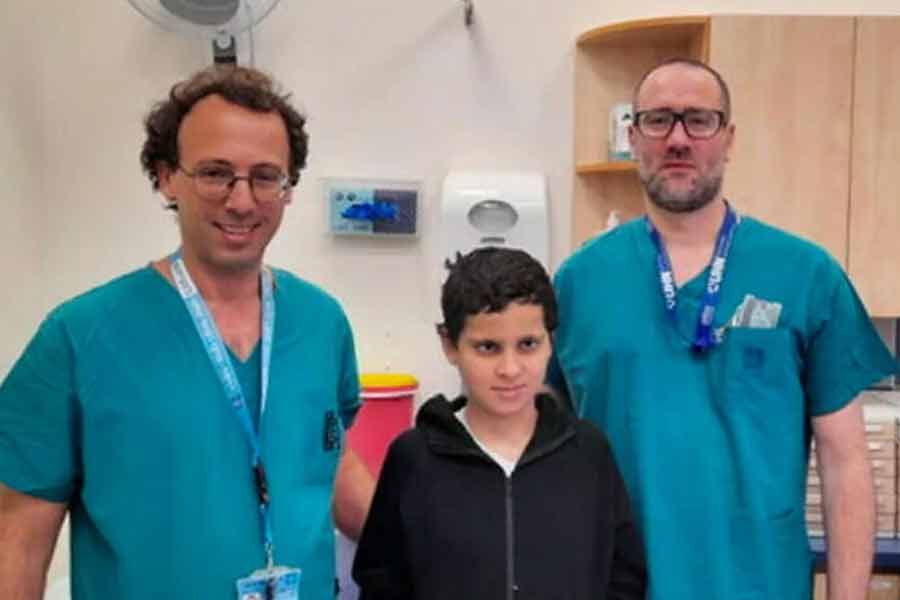 Image of Dr. Ohad Einav and Ziv Asa with 12-year-old Suleiman Hassan at Hadassah Medical Center