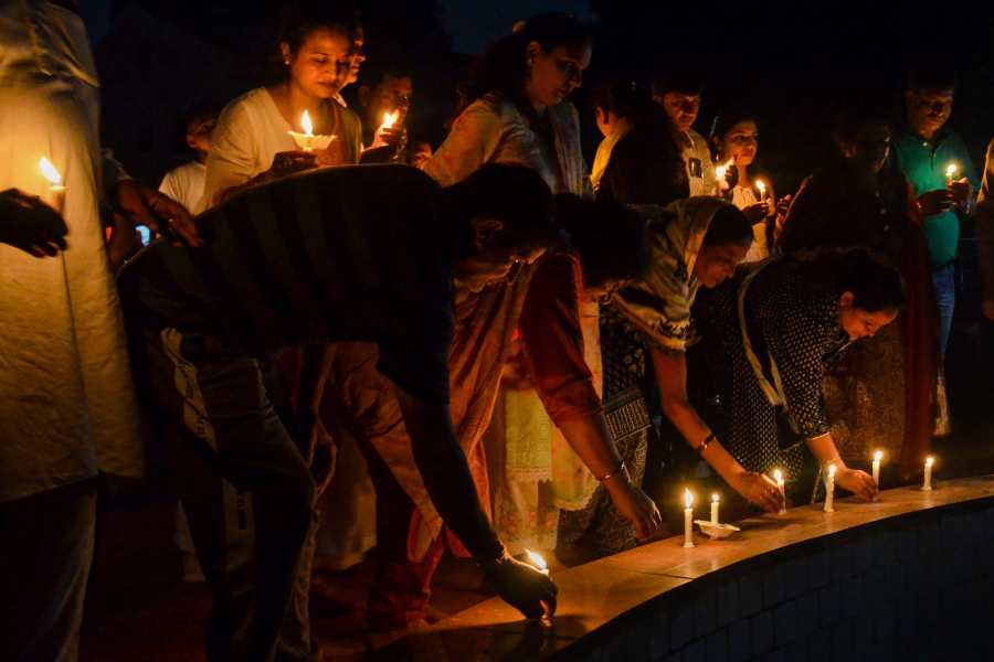 Image of People take part in a candle march to protest against the sexual violence against women in Manipur, in Gurugram