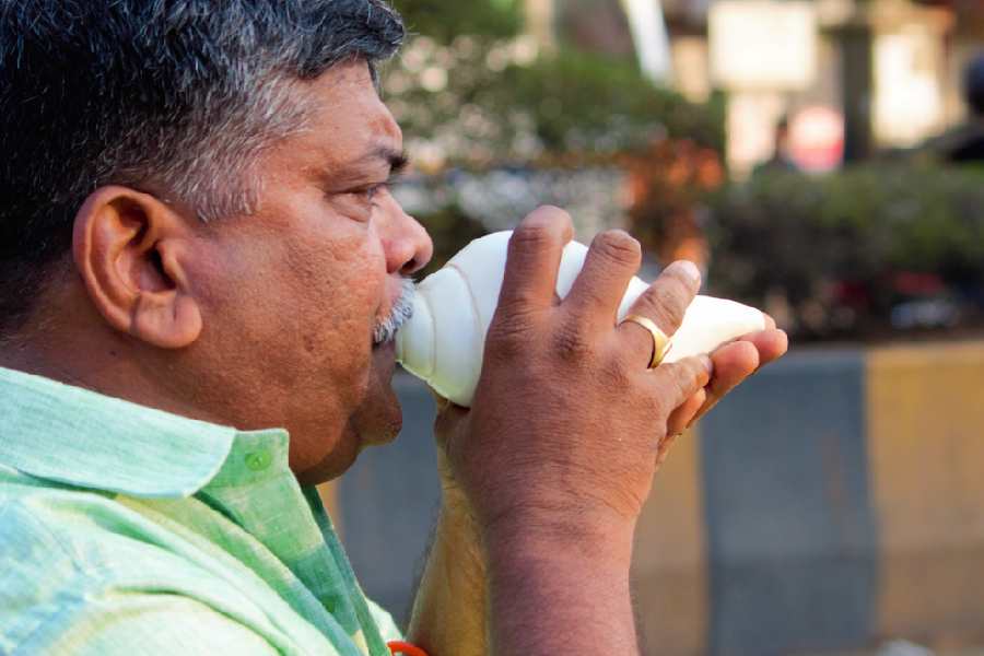 blowing a shankh