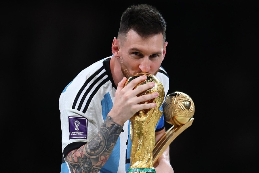 Argentina footballer Lionel Messi with the FIFA World Cup trophy