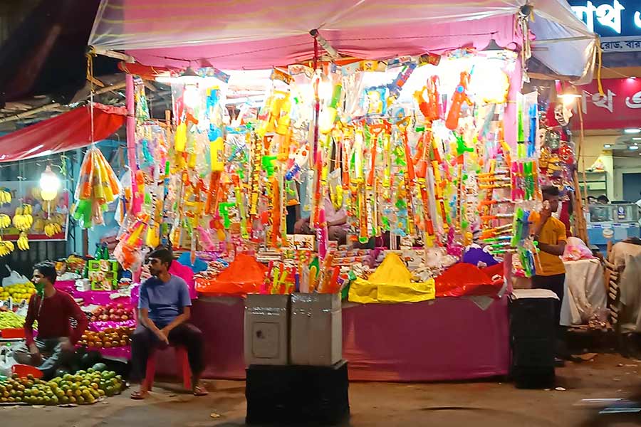 Shopkeeper selling items of Holi Festival