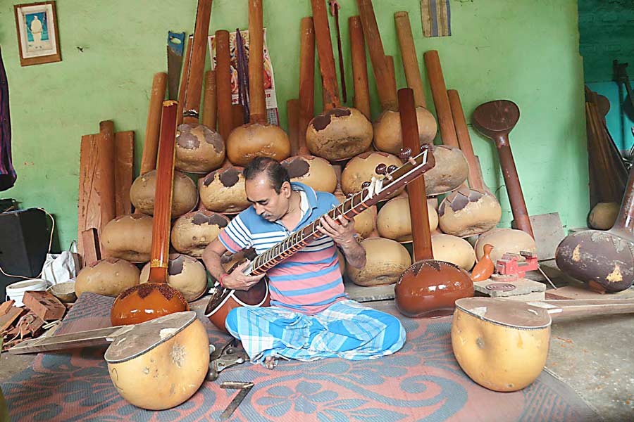 man making musical instruments.