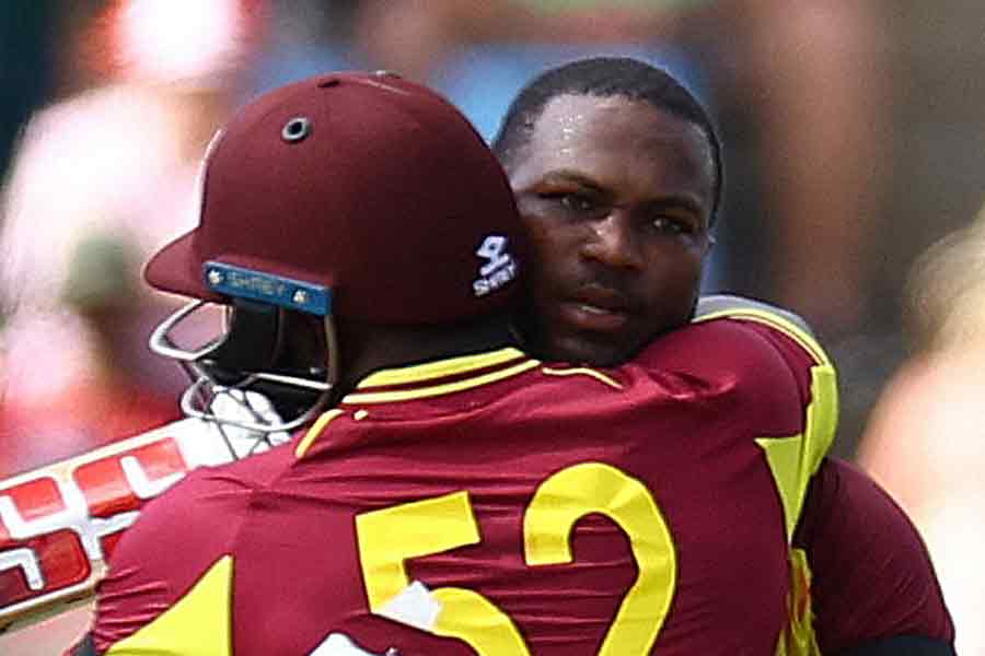 Johnson Charles celebrates reaching his century with Rovman Powell