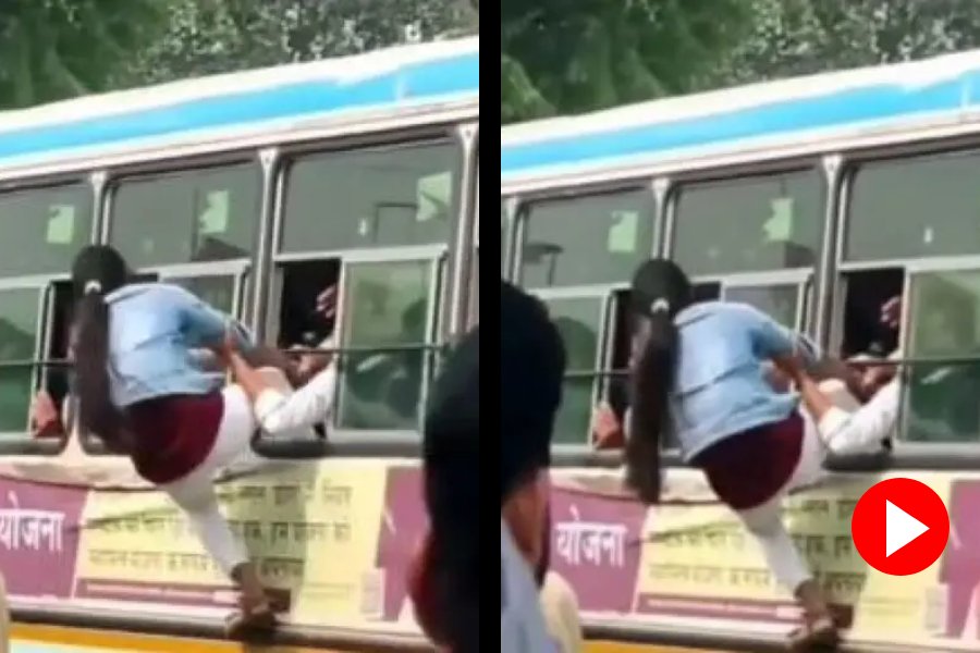 woman climbs an overcrowded bus 