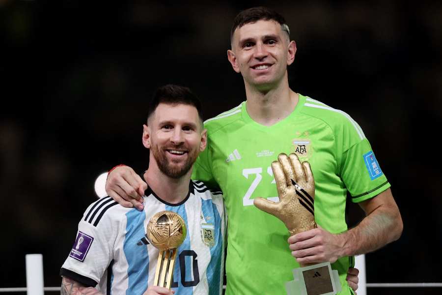 Lionel Messi and Emiliano Martinez