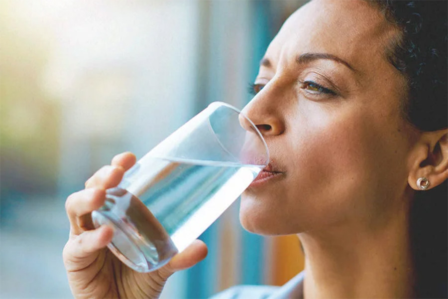 An woman drinking water