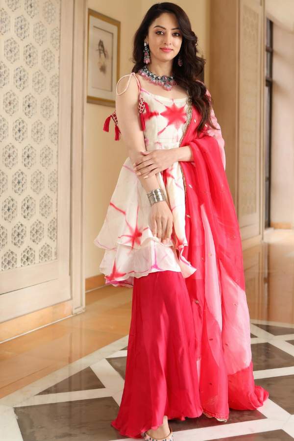 উজ্জ্বল লাল রঙের যদি উপরের টপ বা ব্লাউজ পরেন,  তা হলে নীচে শারারা পরুন। এই শারারা হতে পারে ঘিয়ে সাদা রঙের,  তাতে থাকুক লাল কুরুশের লেস ও লাল সুতোর কাজ দিয়ে বসানো কাঁচের নকশা। সঙ্গের ওড়নাতে থাকুক উজ্জ্বল রঙের ব্লক প্রিন্ট। এতেই আপনি হবেন বন্ধুদের আড্ডায় মধ্যমণি! 