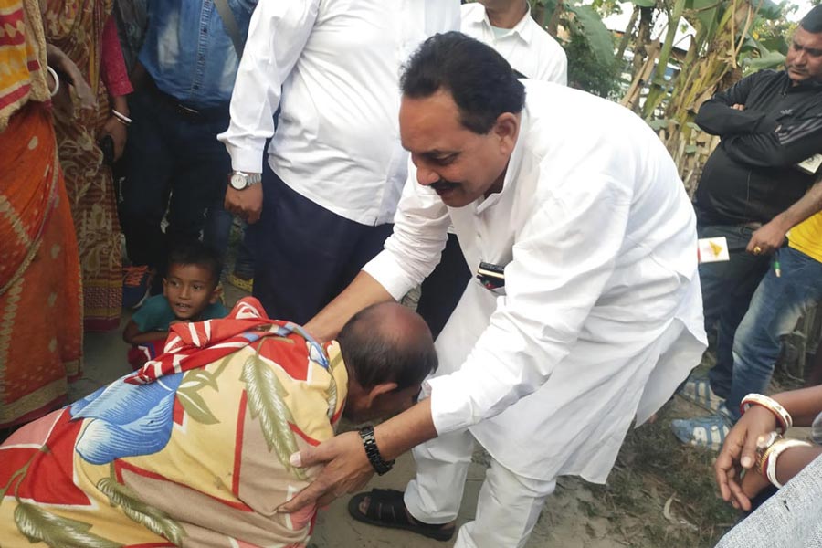 A villager requested local TMC leader by holding his feet to improve the poor condition of road