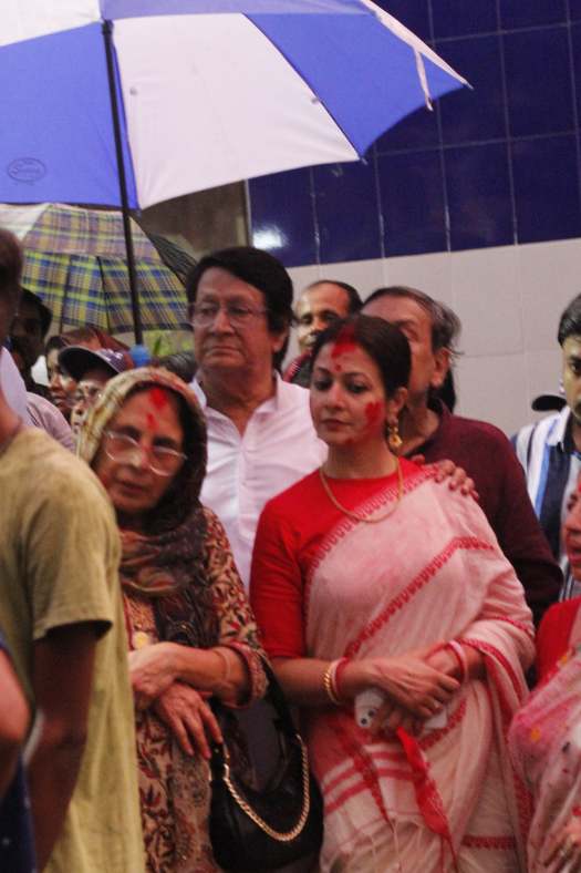 বৃষ্টির মধ্যেও ছাতা মাথায় দিয়ে ঠায় দাঁড়িয়ে রঞ্জিত কোয়েল। ব্যস্ত বিসর্জনে। নিসপাল সিংহ ও তাই। 