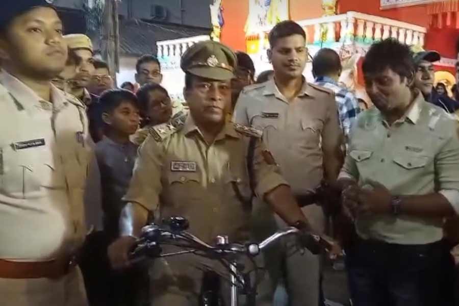 Siliguri Policeman rides cycle during Durga Puja duty