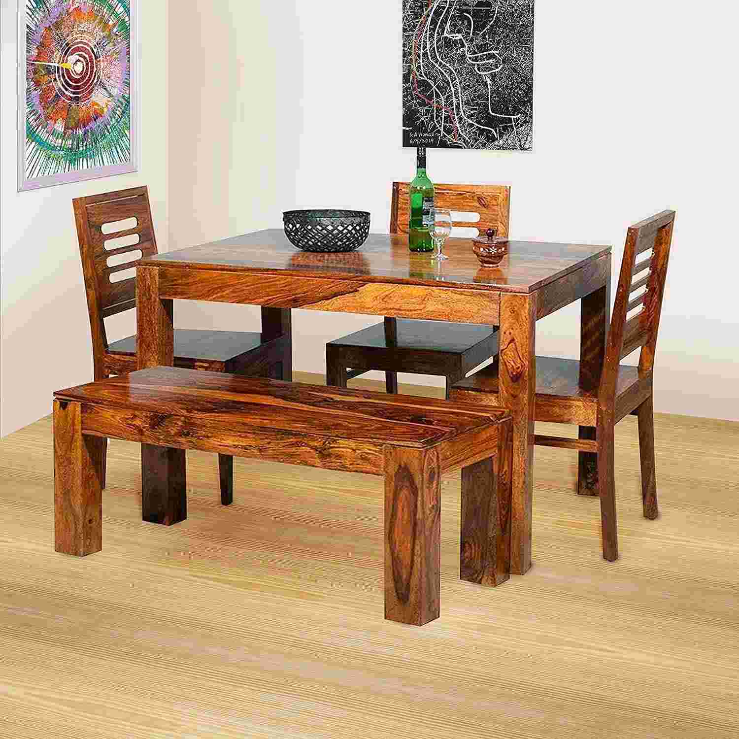 ১. নান্দনিক কারু কাজে কাঠের খাবার টেবিল – পরিপূর্ণ কাঠের তৈরি। কারু কাজে ভরা। সাবেকি। কাঠকে ঘন বাদামী রঙ দিয়ে পালিশ করলেও দারুণ লাগে। ঘরের সাজসজ্জার সঙ্গে মানানোর জন্য অন্য রঙেও পালিশ করা হয়।