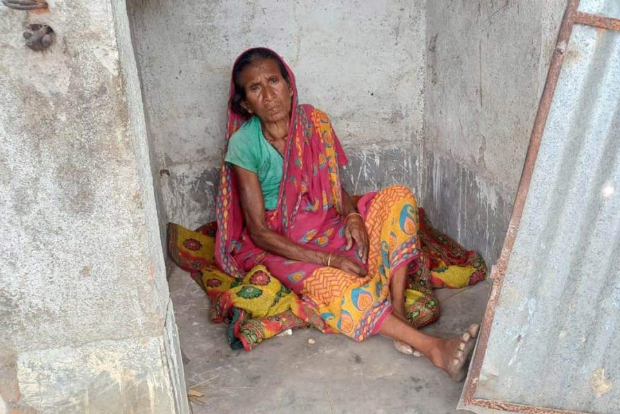 An older woman did not receive house under PMAY scheme, now living in a toilet