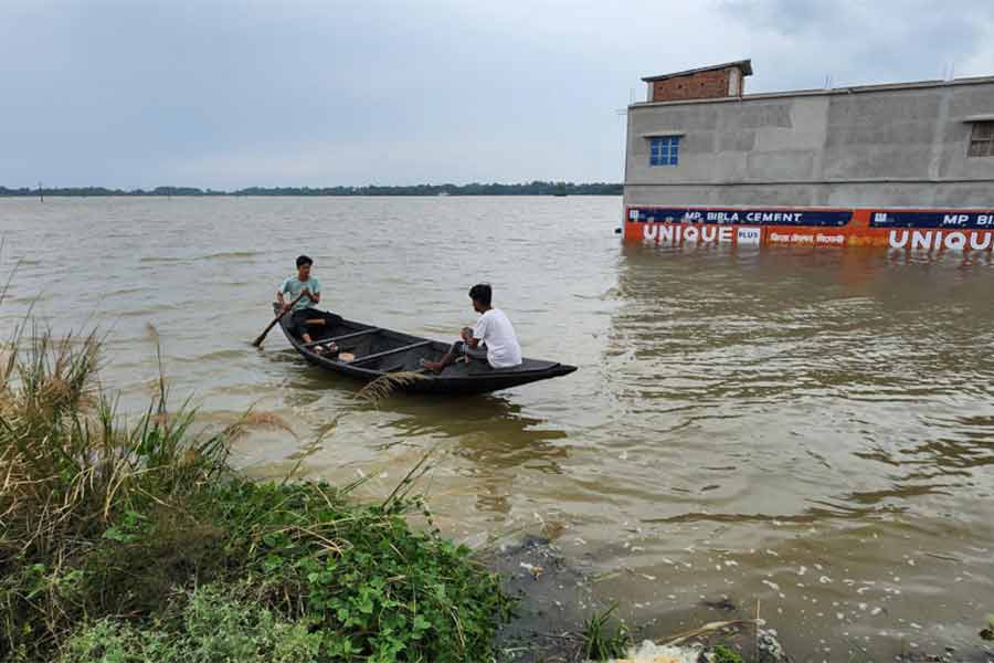 চাষের জমি জলমগ্ন। সেখানে ছোট নৌকা নিয়ে যাতায়াত। খানাকুলের কাকনান বাবলাতলায়।