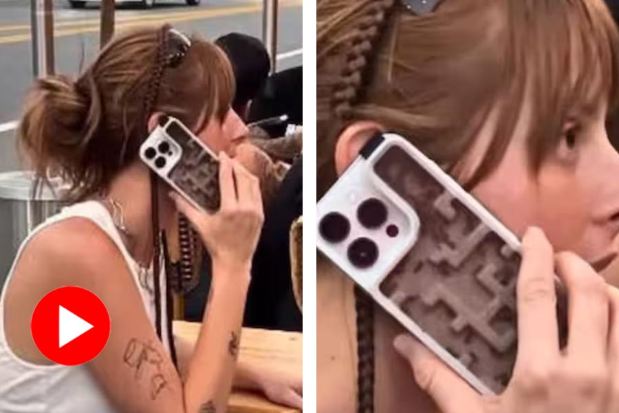 Woman using live ants as phone case