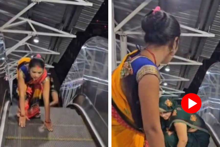 Video of two women struggle while climbing escalator