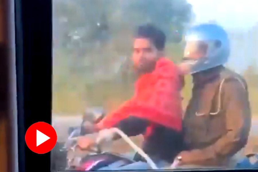 Handcuffed accused rides bike while police sits behind wearing helmet in Uttar Pradesh, video went viral