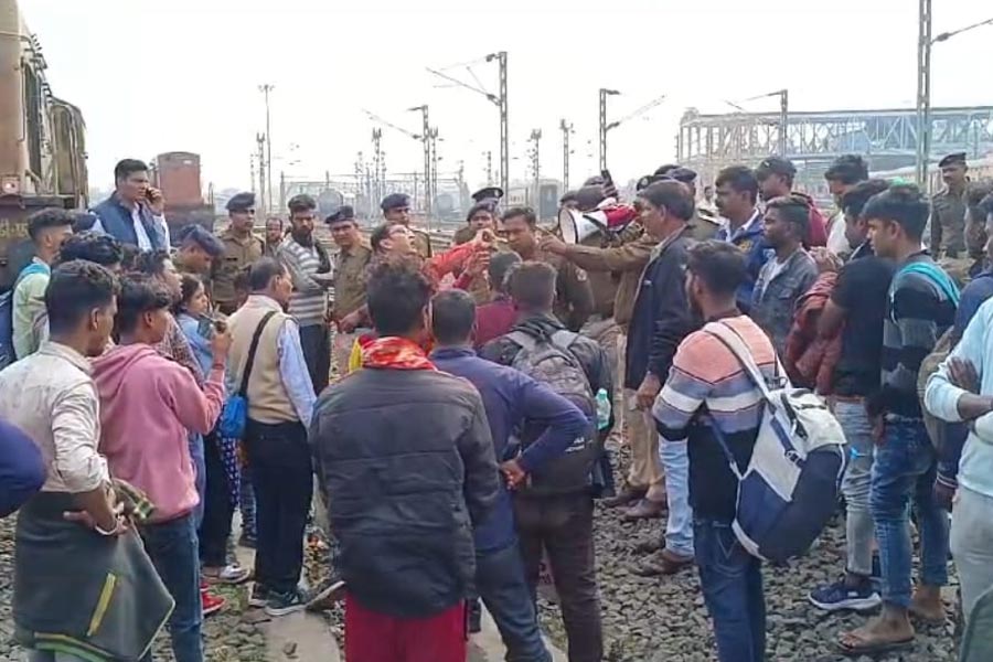 যাত্রীদের বুঝিয়ে অবরোধ তোলার চেষ্টায় আরপিএফ আধিকারিকেরা। মঙ্গলবার শালিমার স্টেশনে।