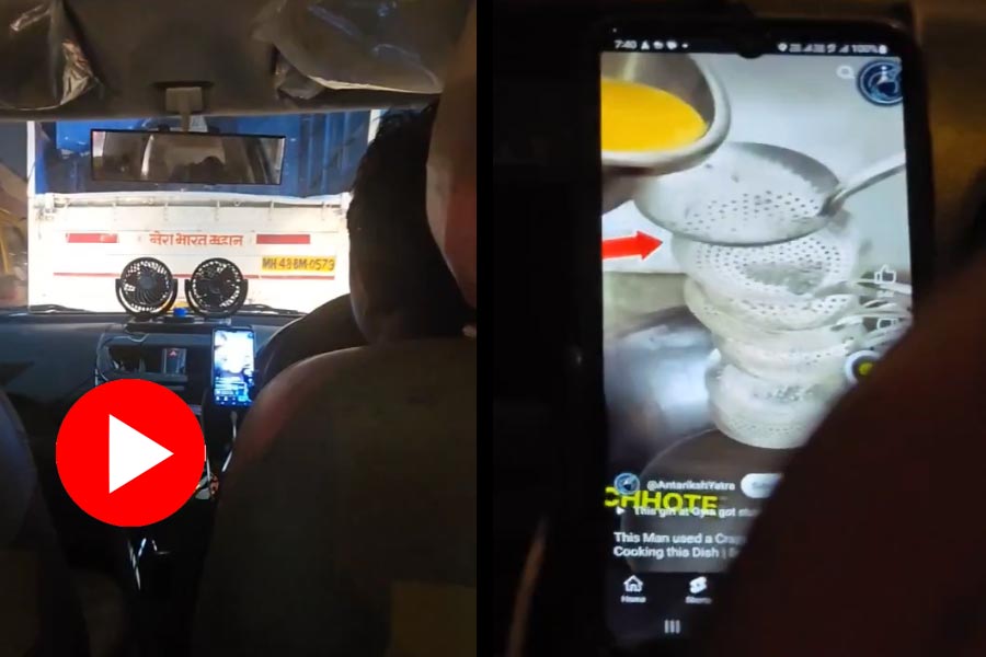 Ola cab driver watching omelette making recipe while driving in Mumbai dgtl