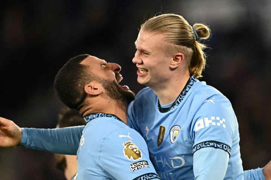 Manchester City\\\'s Erling Haaland celebrates scoring their second goal with Kyle Walker