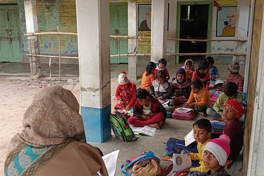 Students of  a Primary school of Patrasayar are forced to attend classes outside i this winter as they do not have a proper classroom