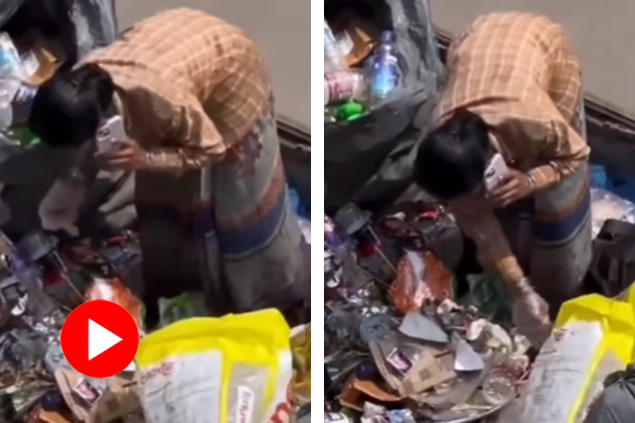 A sanitation worker was unexpectedly spotted using an iPhone