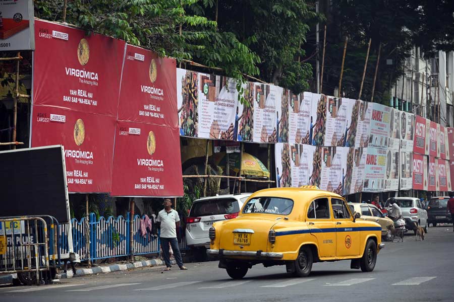 Advertisement banners and hoardings are still not removed from the roads even after the end of Durga Puja in Kolkata