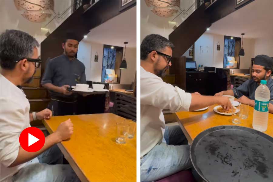 Man’s gesture to invite waiter to share soup