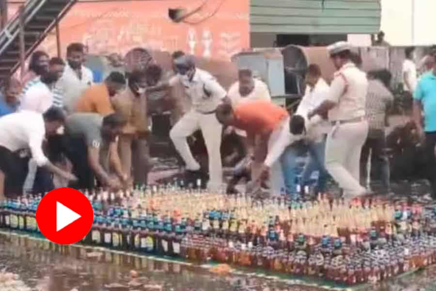 Video of people running with seized liquor bottle in Andhra Pradesh