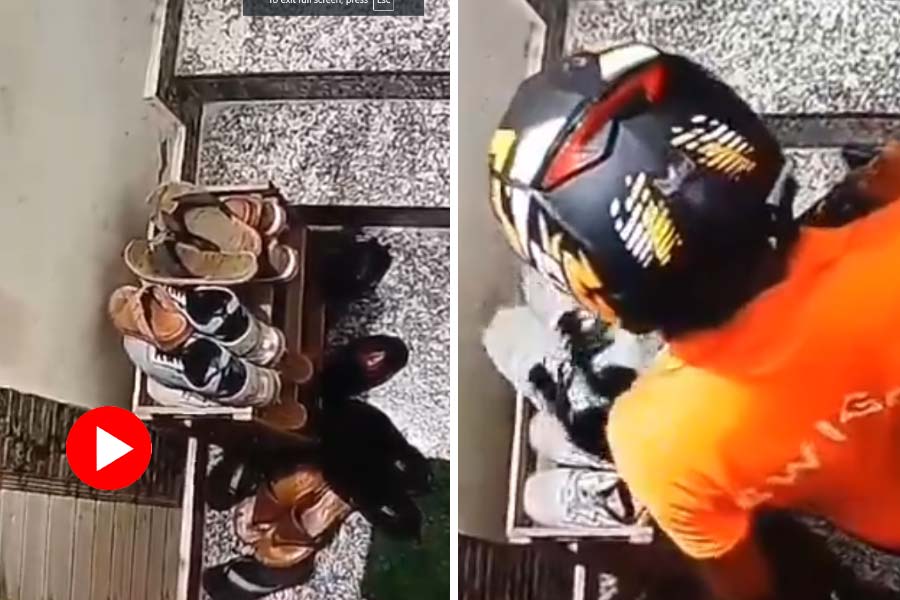 Food delivery person picks shoe from house