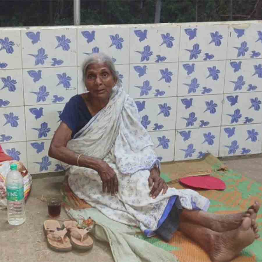 Villagers taking care of an aged lady after her family abandoned her
