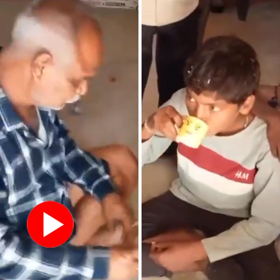 school teacher is seen sitting with students offering alcohol