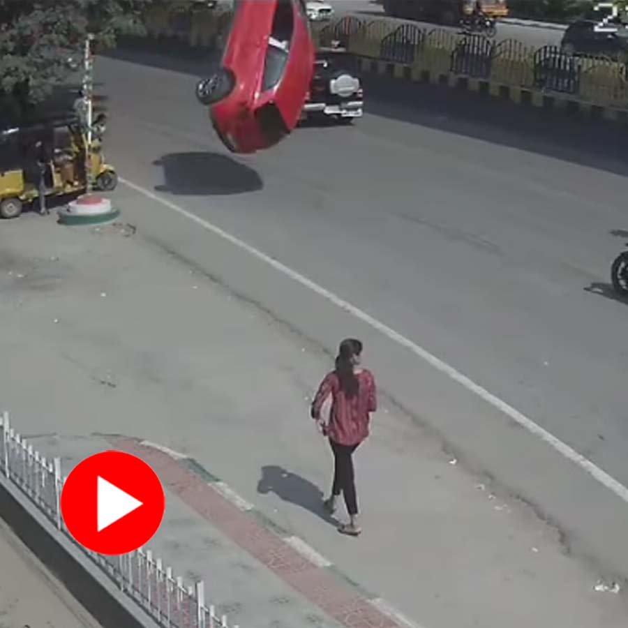 woman avoiding a falling car and signboard