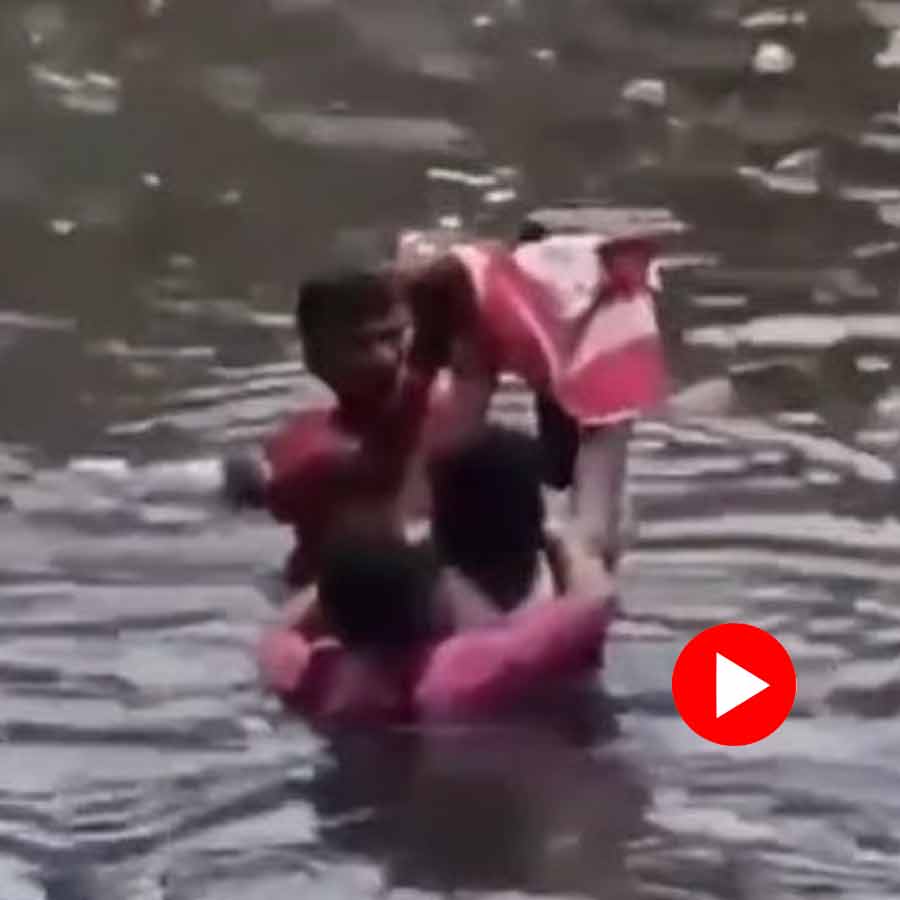 parents are seen carrying their small baby overhead