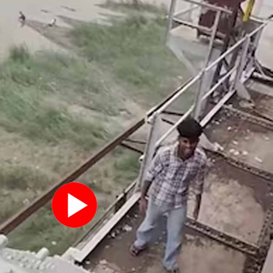young man running along the edge of a moving train