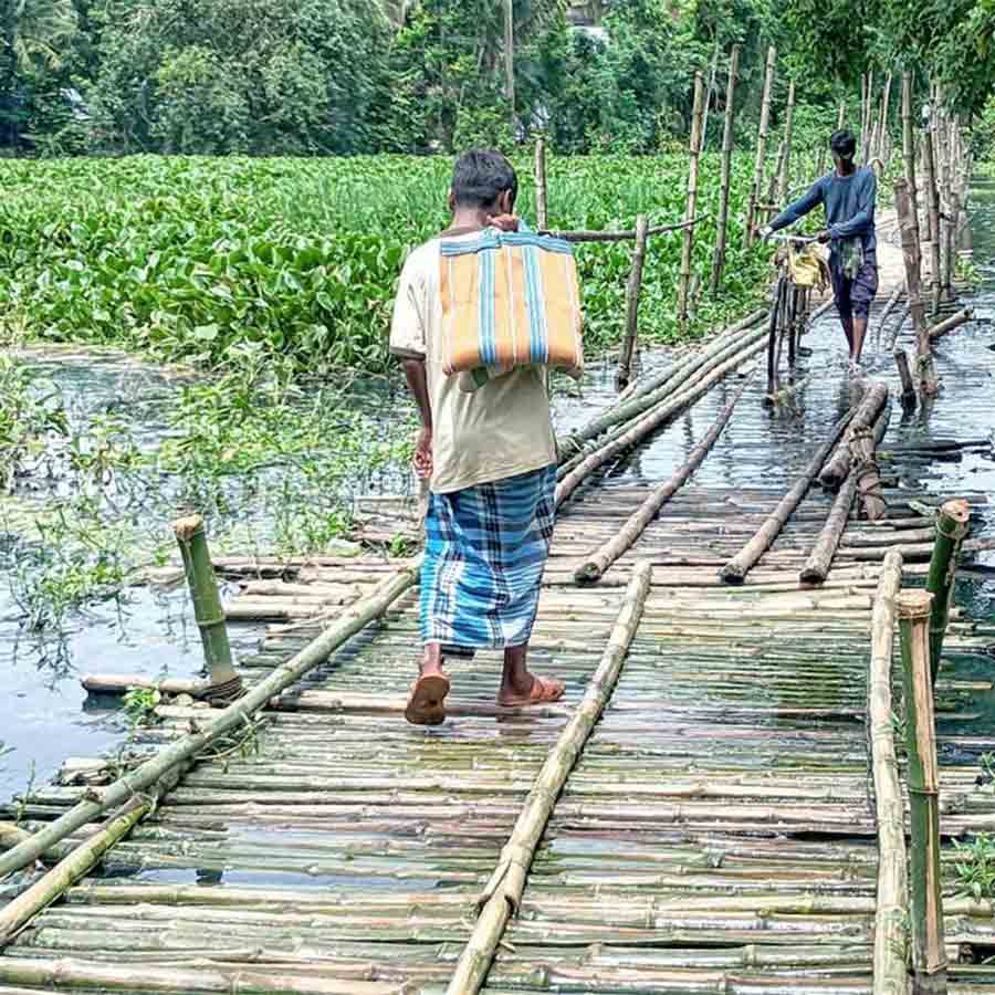 Residents in trouble as Icchamati River almost sunk the only bamboo bridge to cross at Bagda