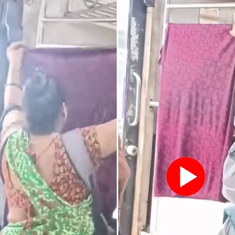 woman drying her clothes inside a Mumbai local train