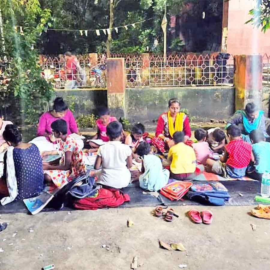 A group of young men and women are teaching children wandering around the station in Sonarpur