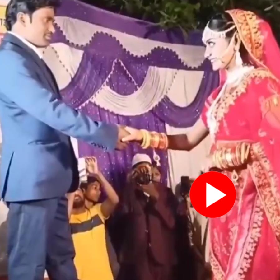 bride pushes groom as he gave hands towards her