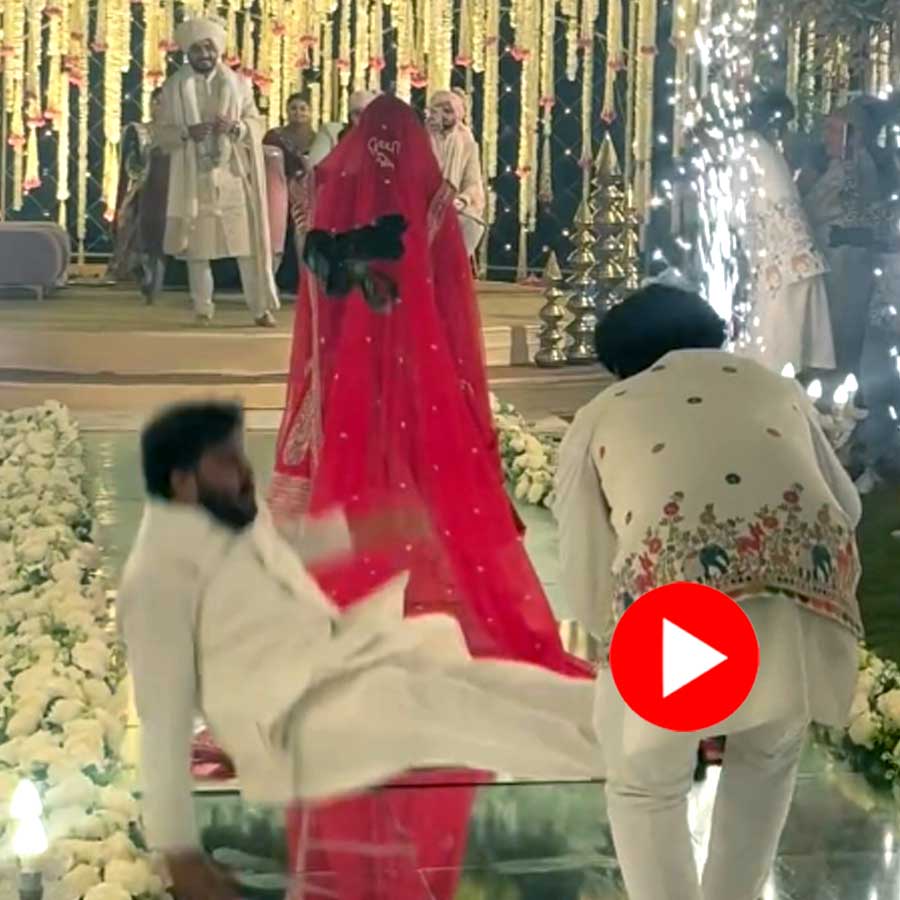 Video shows wedding photographer fall near Bride but get up quickly