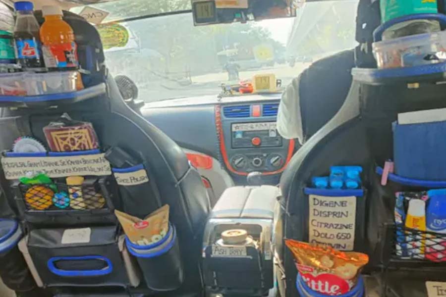 An app cab driver converting his vehicle into a mobile convenience store