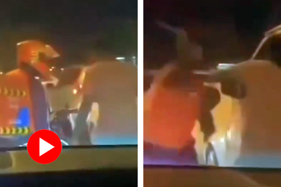 A video shows a car driver picking a fight with a delivery boy on the road