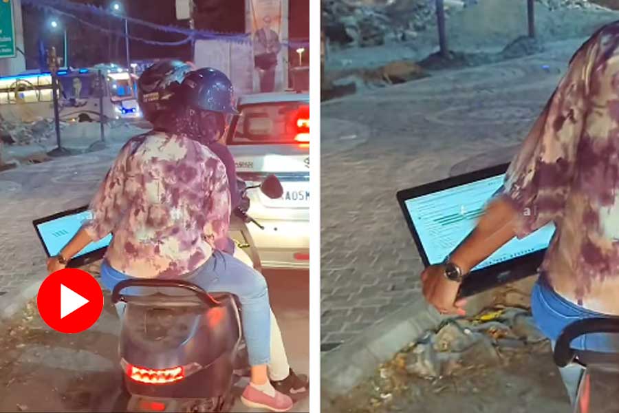 Woman works on laptop while being stuck on traffic jam in Bengaluru dgtl