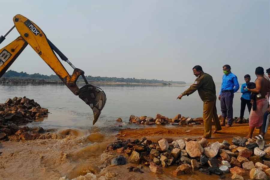 Barabani Block Administration demolished a road that was built over Ajay river