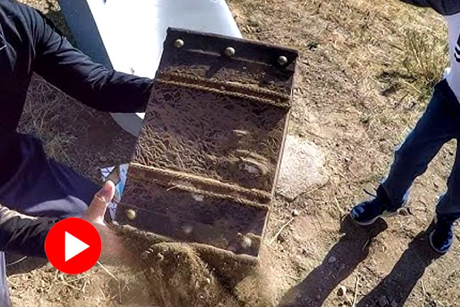 A video shows a man unearthing an old box filled with gold bracelets and statues went viral