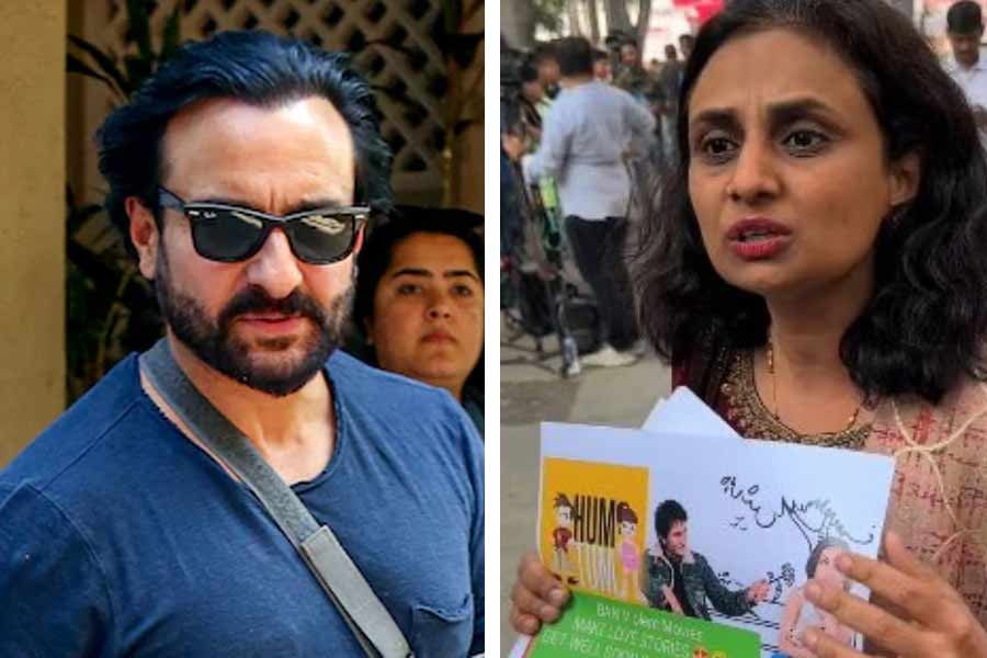 A female fan of Saif Ali Khan stands in front of Leelavati Hospital with a message written on a placard