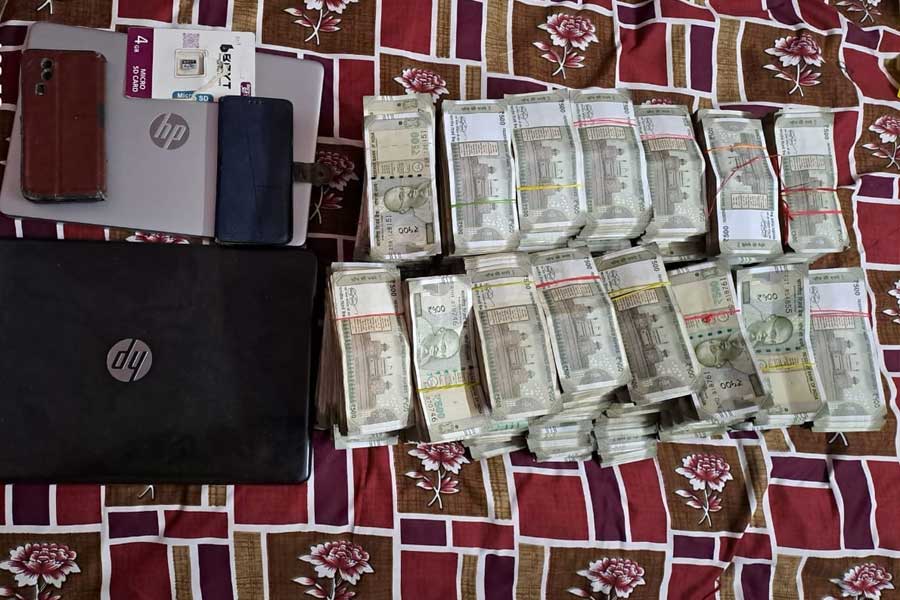 ধৃত উৎপল শিকদারের বাড়ি থেকে উদ্ধার নগদ টাকা, ল্যাপটপ এবং মোবাইল।