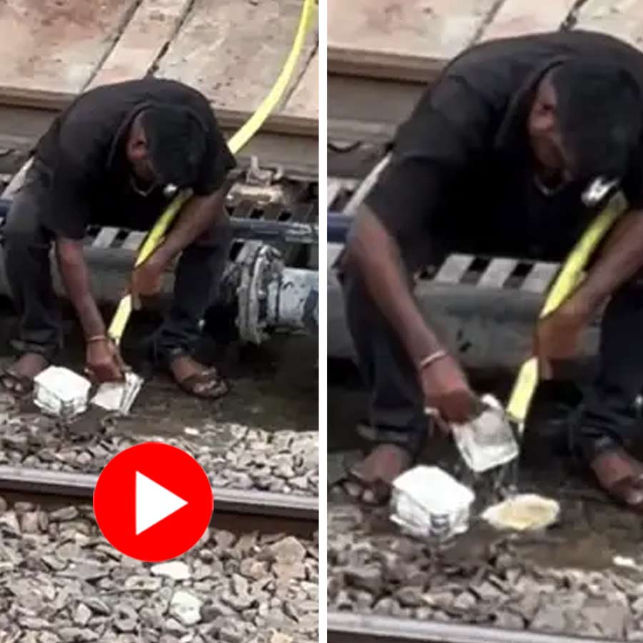 man washing aluminium boxes to reuse a rail station