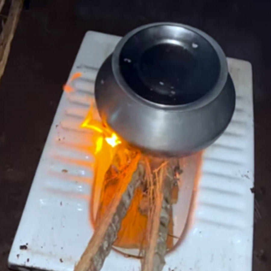 a man is cooking something using Indian style toilet