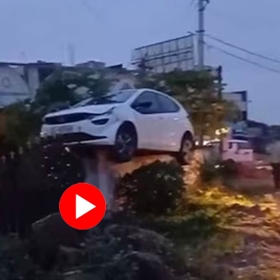 drunk driver crashes a car on top of a house’s wall